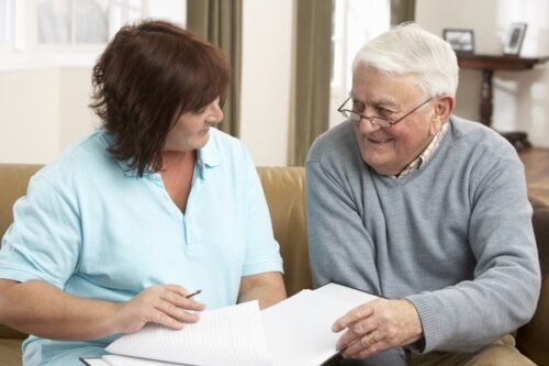 Senior talking with healthcare professional about respite care.